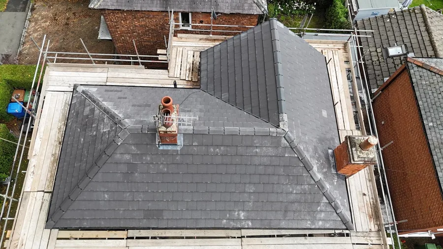 Aerial view straight down on a completed grey flat tile hipped roof in Beverley with full scaffold