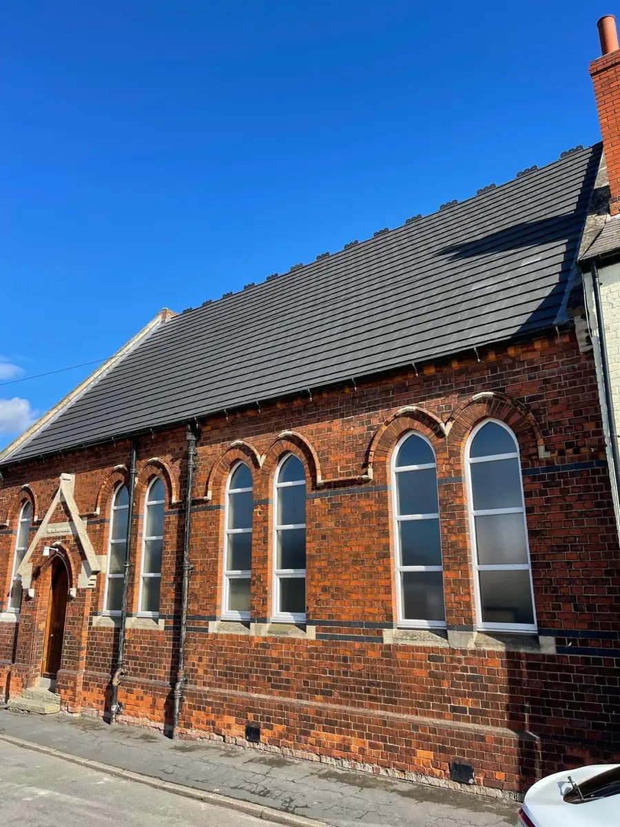Re-roofed Victorian chapel in red brick with a new grey tiled roof