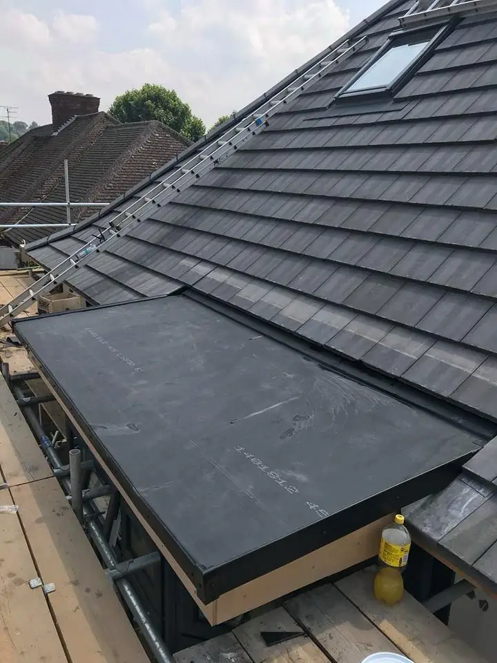 EPDM flat roof on a garden room beside a grey tiled main roof