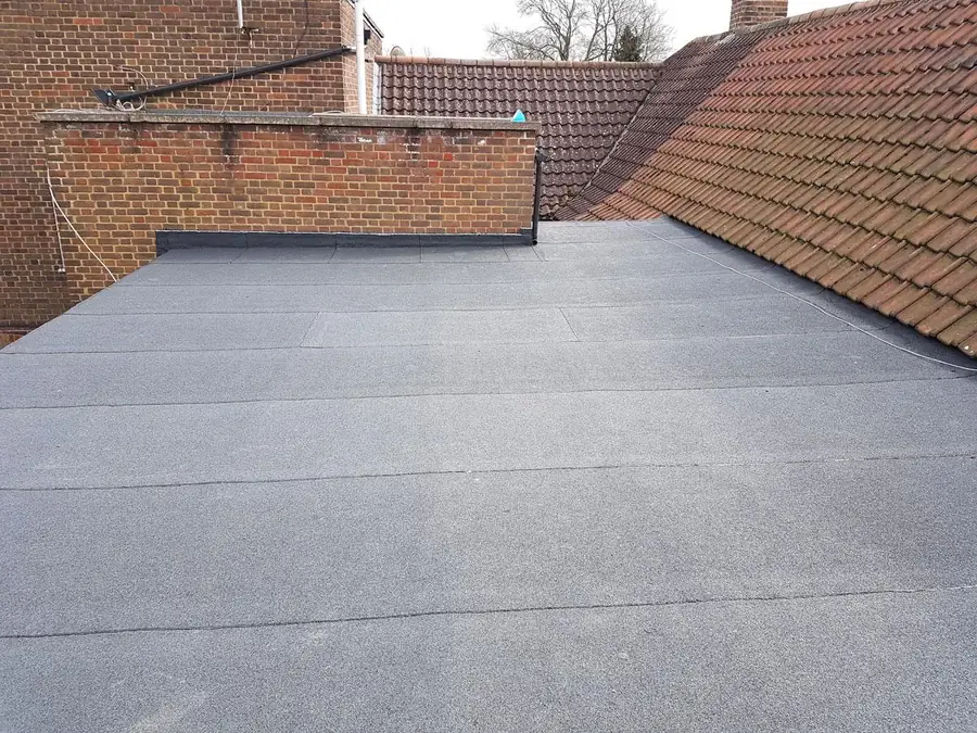 Torch on felt flat roof finished neatly against a parapet wall