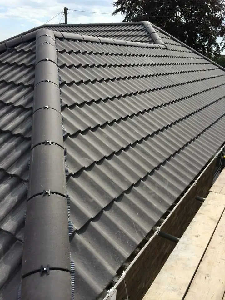 Anthracite pantile roof with mechanically fixed dry hip and ridge