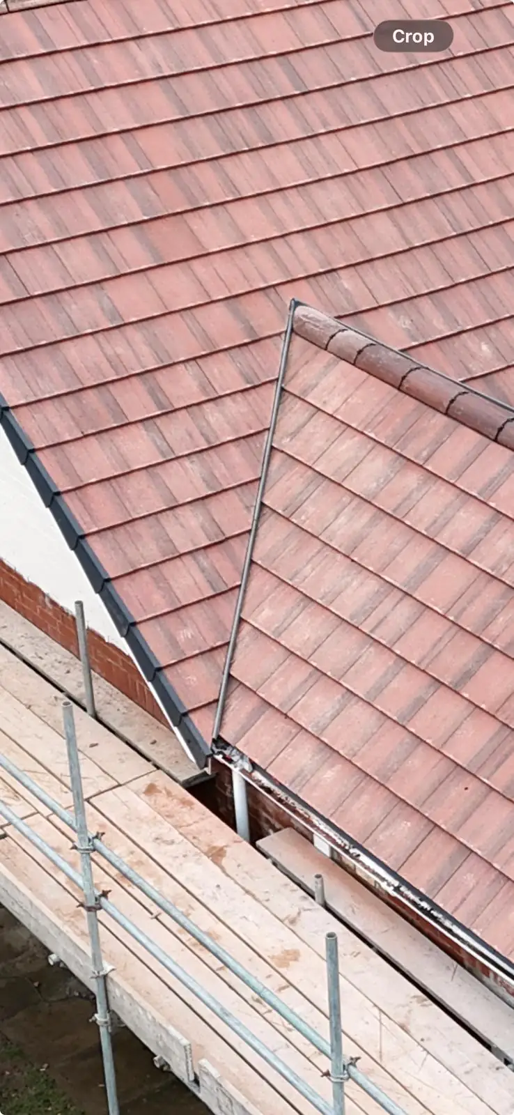 New plain tiled hipped roof with scaffold still standing