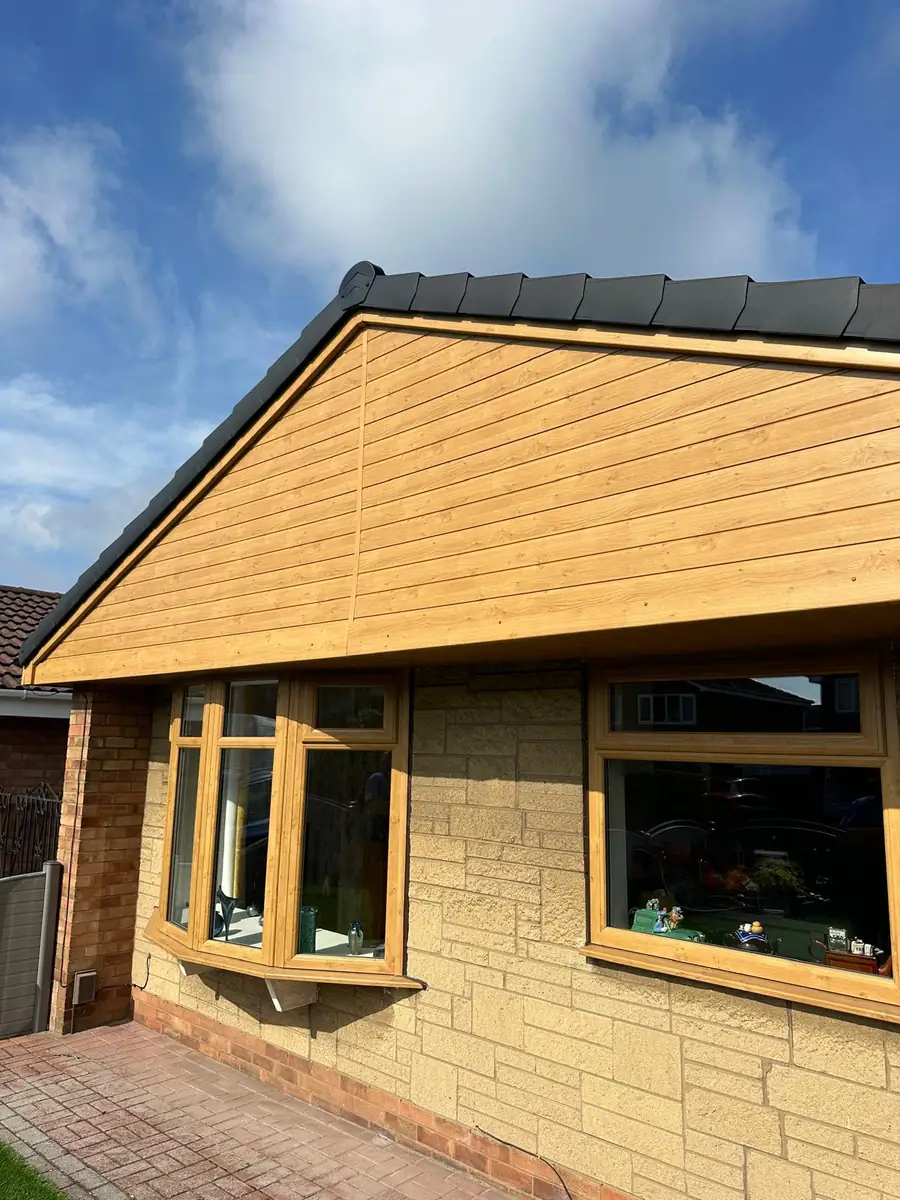 Golden oak cladding to a gable end with anthracite guttering